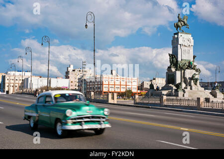 Horizontal view of a classic American car driving down the Malecon in Havana, Cuba. Stock Photo