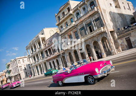 Horizontal view of classic American cars driving down the Malecon in Havana, Cuba. Stock Photo