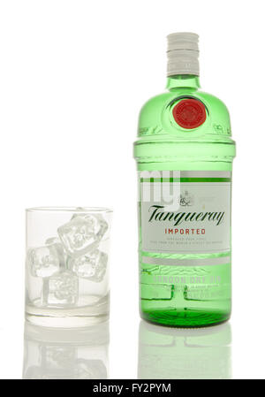 Winneconne, WI - 10 March 2016: A bottle of Tanqueray gin with a empty glass of ice. Stock Photo