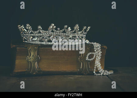 low key image of beautiful diamond queen crown on old book. vintage filtered. selective focus Stock Photo