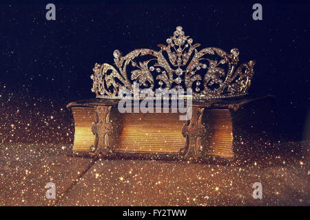 low key image of beautiful diamond queen crown on old book. vintage filtered. selective focus Stock Photo