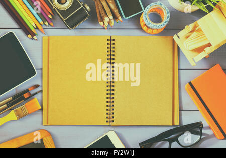 top view photo of blank notebook, old camera and school supplies on wooden table. vintage filtered Stock Photo