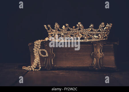 low key image of beautiful diamond queen crown on old book. vintage filtered. selective focus Stock Photo