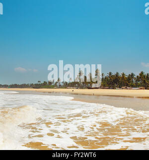 Kolva, India - April 20, 2016: Goan beach panorama with sea, fisherman boats and palms Stock Photo