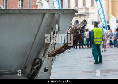 Municipal Dustman Worker with Cleaning Tools in Public Streets Stock Photo