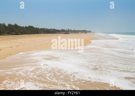 Kolva, India - April 20, 2016: Goan beach panorama with sea, fisherman boats and palms Stock Photo