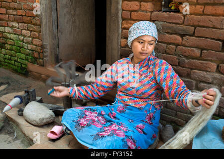 A woman spins wool at the small village of Bungamati, Nepal Stock Photo