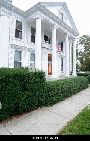 large federal style house in Stonington Connecticut.  The home has large portico with tall columns. Stock Photo