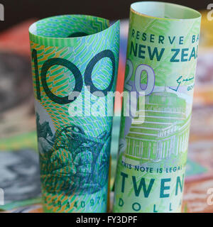 Australian and New Zealand rolled notes with a background of cash. Stock Photo