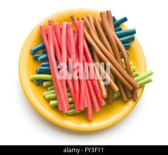 Sweet gummy sticks with different flavors. Tasty fruity candies on white background. Stock Photo