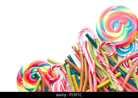 Different candies. Gummy sticks and various lollipops isolated on white background. Top view. Stock Photo
