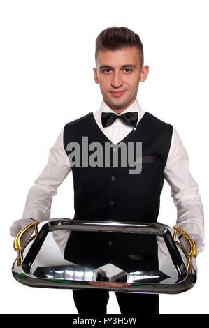 A young boy waiter with a tray. Isolated background and clipping path Stock Photo