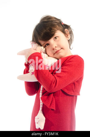 Sweet beautiful little girl playing with a moon plush isolated on white background Stock Photo