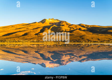 Dormant volcano at the salt lake of Solar De Uyuni in Bolivia Stock Photo