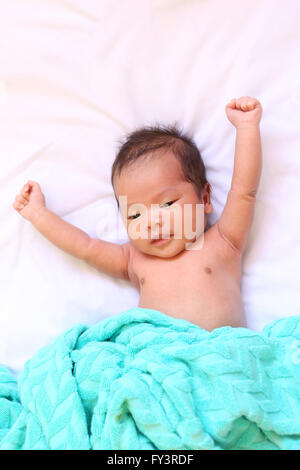 Newborn baby of asia relax in a good mood on white bed and looked happy,good health. Stock Photo