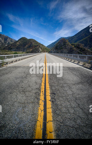Bridge leads over canyon in the mountains above Los Angeles California. Stock Photo