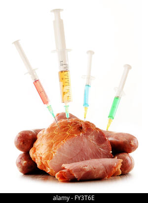 Syringes and meat isolated on white. Genetically modified food. GMO Stock Photo