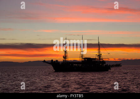 Wooden vintage frigate 'Arabella' cruise bar caffe, touring with passengers in Thermaic gulf at sunset. Thessaloniki, Greece Stock Photo