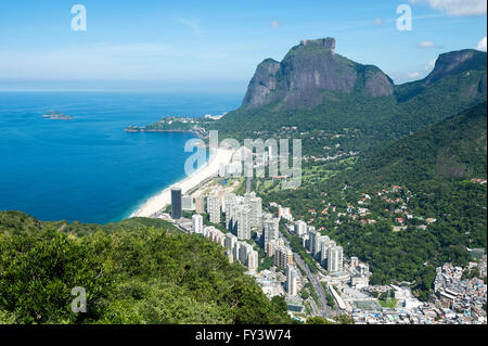 Scenic skyline view from above Sao Conrado Beach with Pedra da Gavea mountain and the favela community Rocinha, Rio de Janeiro Stock Photo