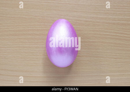 Purple of easter eggs on wood background,Handmade painted for design happy easter day. Stock Photo