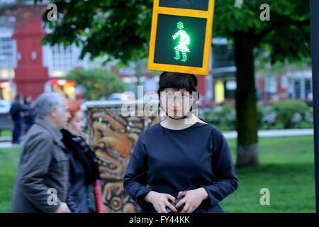The artist Kubra Khademi (Ghor, Afghanistan, 1989) toured the streets of Gijon semaphore disguised for a performance titled 'Kubra and crosswalks III' with the aim of combating machismo. On her head she wore an orange box, simulating a traffic light with two loops, including two bulbs, one green and one red, and on them two black cardboard with holes in the shape of a woman. A woman with dress to criticize the machismo that is behind a semaphore for using figures pants. Stock Photo