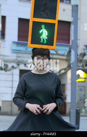The artist Kubra Khademi (Ghor, Afghanistan, 1989) toured the streets of Gijon semaphore disguised for a performance titled 'Kubra and crosswalks III' with the aim of combating machismo. On her head she wore an orange box, simulating a traffic light with two loops, including two bulbs, one green and one red, and on them two black cardboard with holes in the shape of a woman. A woman with dress to criticize the machismo that is behind a semaphore for using figures pants. Stock Photo