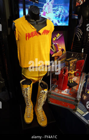 SAN JOSE - MARCH 28: WWE Legend Hulk Hogan Hulkamania yellow outfit, boots, action figure and posters on displays at WWE Axxess event at the McEnery Convention Center in San Jose, California on March 28, 2015. Stock Photo
