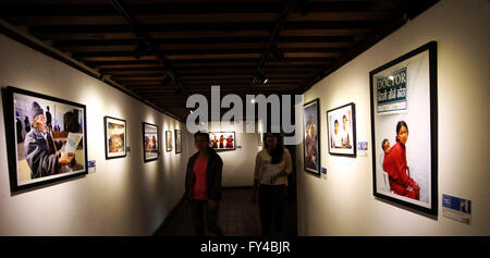 Lalitpur, Nepal. 21st Apr, 2016. Visitors watch the photos at the 'Nepal rising' photo exhibition organized by the United Nations, showcasing photos of rebuilding Nepal one year after the earthquake at Patan Museum in Lalitpur, Nepal, April 21, 2016. © Sunil Sharma/Xinhua/Alamy Live News Stock Photo