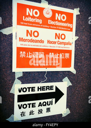 'No Loitering or Electionering' and 'Vote Here' Directional Signs in English, Spanish and Chinese, NYC Polling Location, USA Stock Photo