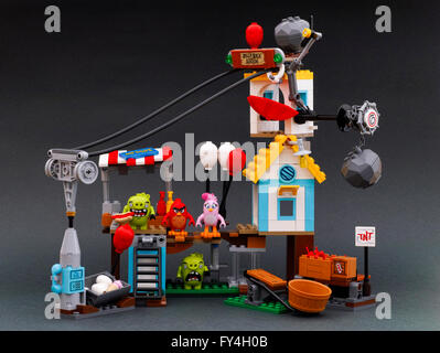 Lego Angry Birds Pig City Teardown set. Set includes catapult, box of TNT, hot dog stand, zip-lining with umbrella. Stock Photo