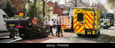 Black Audi car upside down, white transit, labour party banner, ambulance, policeman, firemen, fire engine, police van, bus Stock Photo