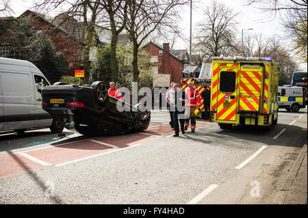 Black Audi car upside down, white transit, labour party banner, ambulance, policeman, firemen, fire engine, police van, bus Stock Photo