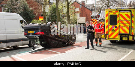 Black Audi car upside down, white transit, labour party banner, ambulance, policeman, firemen, fire engine, police van, bus Stock Photo