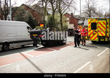 Black Audi car upside down, white transit, labour party banner, ambulance, policeman, firemen, fire engine, police van, bus Stock Photo