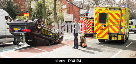 Black Audi car upside down, white transit, labour party banner, ambulance, policeman, firemen, fire engine, police van, bus Stock Photo