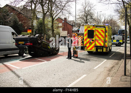 Black Audi car upside down, white transit, labour party banner, ambulance, policeman, firemen, fire engine, police van, bus Stock Photo