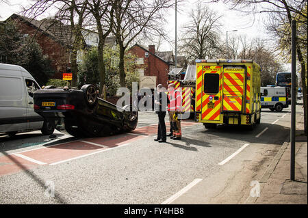 Black Audi car upside down, white transit, labour party banner, ambulance, policeman, firemen, fire engine, police van, bus Stock Photo