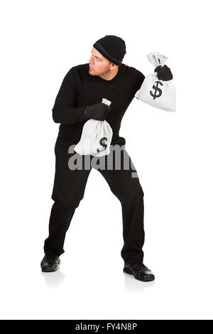 Series with Caucasian male as a burglar or thief, sneaking in a window, carrying stolen goods, etc.  Isolated on white backgroun Stock Photo