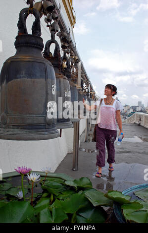 Tourist rings the temple bells, at the Golden Mount Temple in Bangkok, Thailand Stock Photo