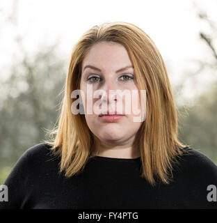 Classic Head Shot. A young woman looks directly at the camera in an intense and honest manner. Stock Photo