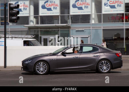 2004 Maserati GranTurismo sports car;  Classic coupe High value cars & side view of traffic on 'The Strand' the main highway across the front of Liverpool City, adjacent to dockland and the main tourist attractions, Merseyside, UK Stock Photo