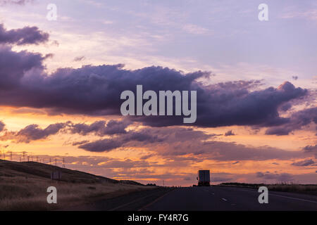 Scenes along Interstate 5 near Patterson California late in the day with car and truck traffic and the sun Stock Photo