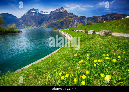 Beautiful sea promenade in Sisikon village with the view of Swiss Alps and Lucerne lake, Switzerland Stock Photo