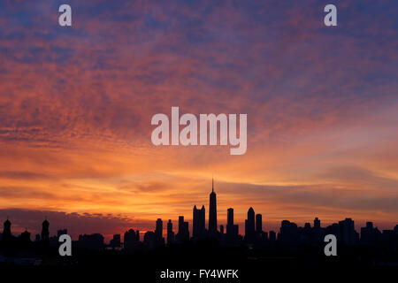 Downtown Chicago skyline is silhouetted at sunrise as seen from Wicker Park in Chicago, Illinois, United States of America Stock Photo