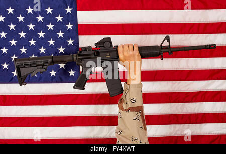 AR15 M4A1 Soldier Man with  M16 Style Weapon Automatic Rifle on USA Flag concept freedom patriotism veteran Stock Photo