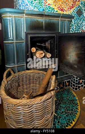 Masonry heater / masonry stove / ceramic stove, tile stove in eco house to save energy Stock Photo