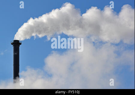 Conceptual image showing air pollution from industry showing chimney issuing fume into the atmosphere Stock Photo