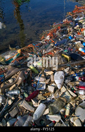 Plastic rubbish and other non-degradable waste in water of canal Stock Photo