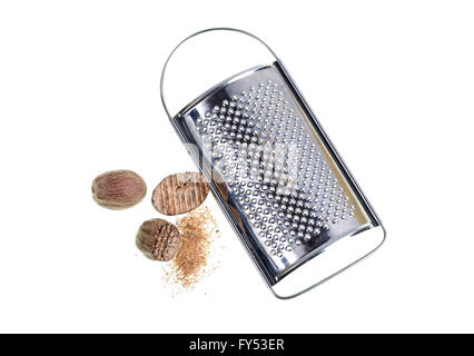 Nutmeg, grated nutmeg and fine grater on white background. Stock Photo