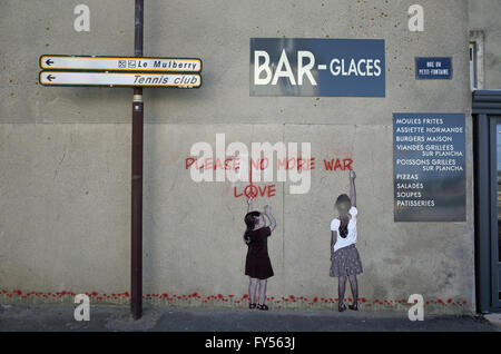 Wall painting of children painting 'Please No More War - Love' on wall in rural France Stock Photo